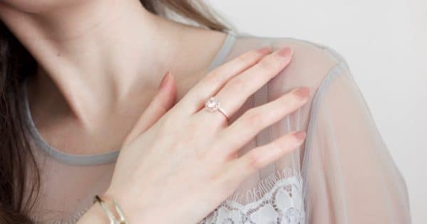 woman in white lace top wearing gold ring